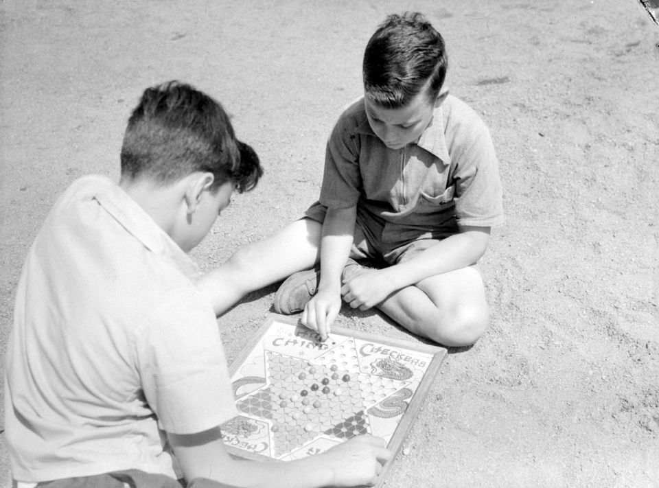 Two boys, David Shefler and John Hennessey, playing to "Hop Ching Checkers" (Chinese checkers) in MacDonald Park Summer Camp, Montreal.