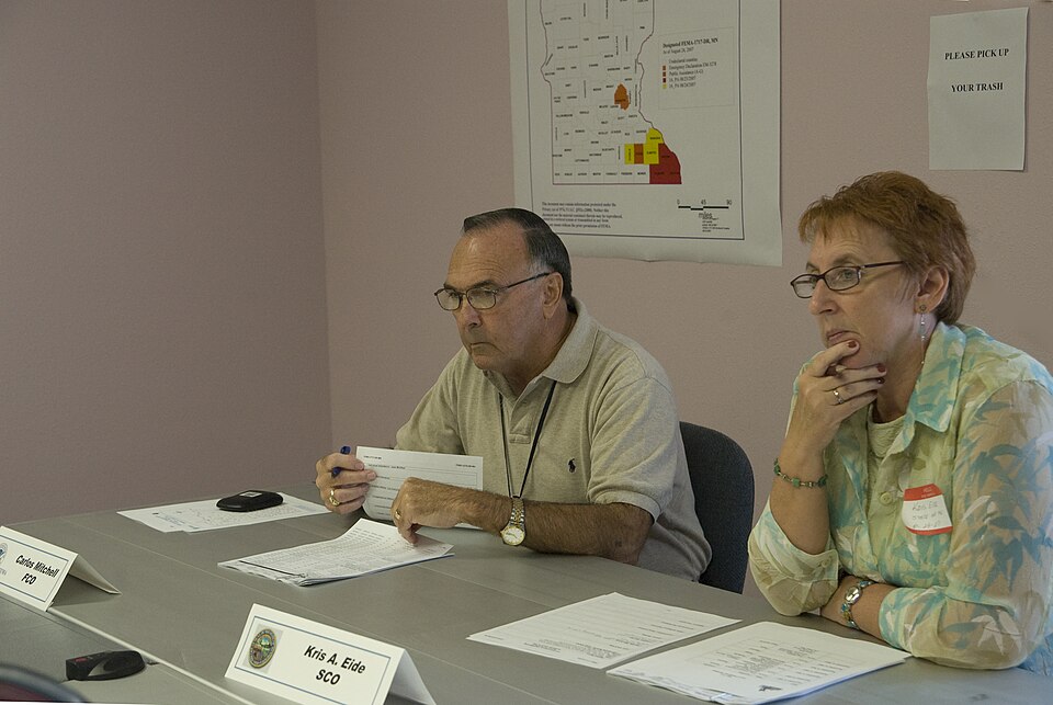 Rochester, MN, August 29, 2007 -- Carlos Mitchell, FEMA Federal Coordinating Officer (FCO) and Kris Eide, the MN State Coordinating Officer (SCO) attend a briefing at the Joint Field Office (JFO).  They being briefed about recent flooding issues that occurred in Minnesota earlier this month. FEMA is