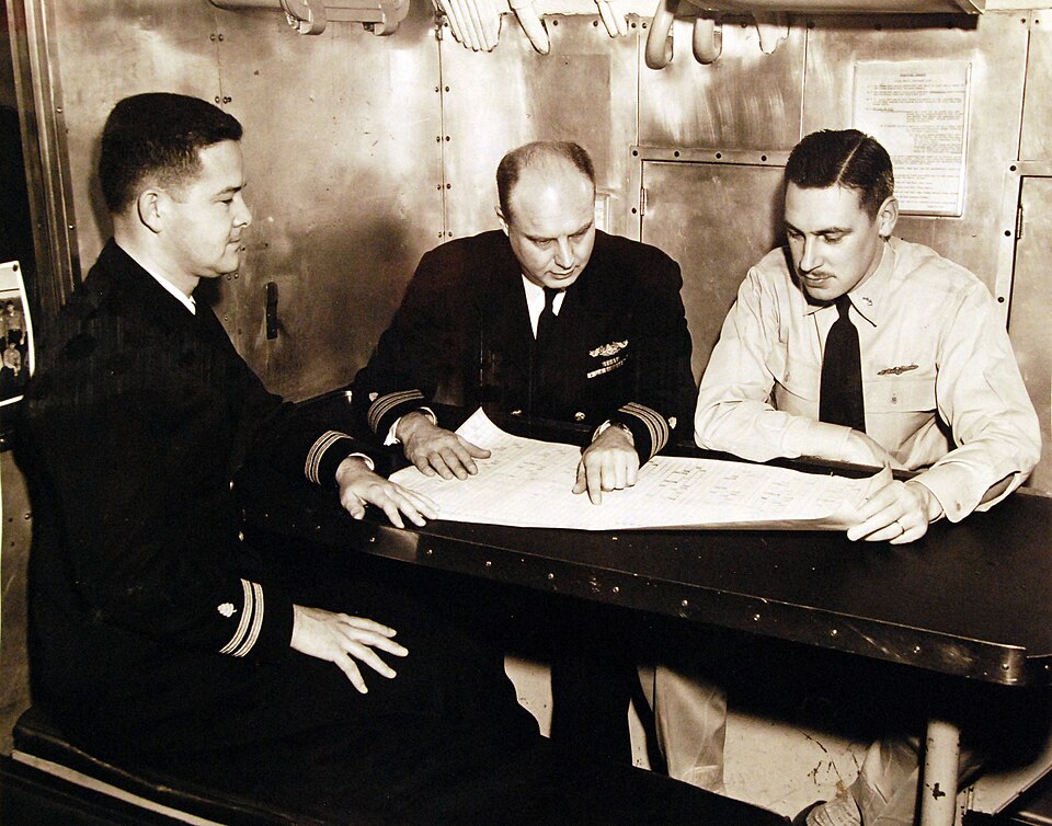 330-PS-3184 (USN 708795):  Discussing progress of the operation on board USS Haddock (left to right) are:  Lieutenant Pierce P. Newman, Jr., MC, USN, Project Officer, who set up the tests; Commander Gerald J. Duffner, MC, USN, in charge of the U.S. Navy Medical Research Laboratory, who has overall s