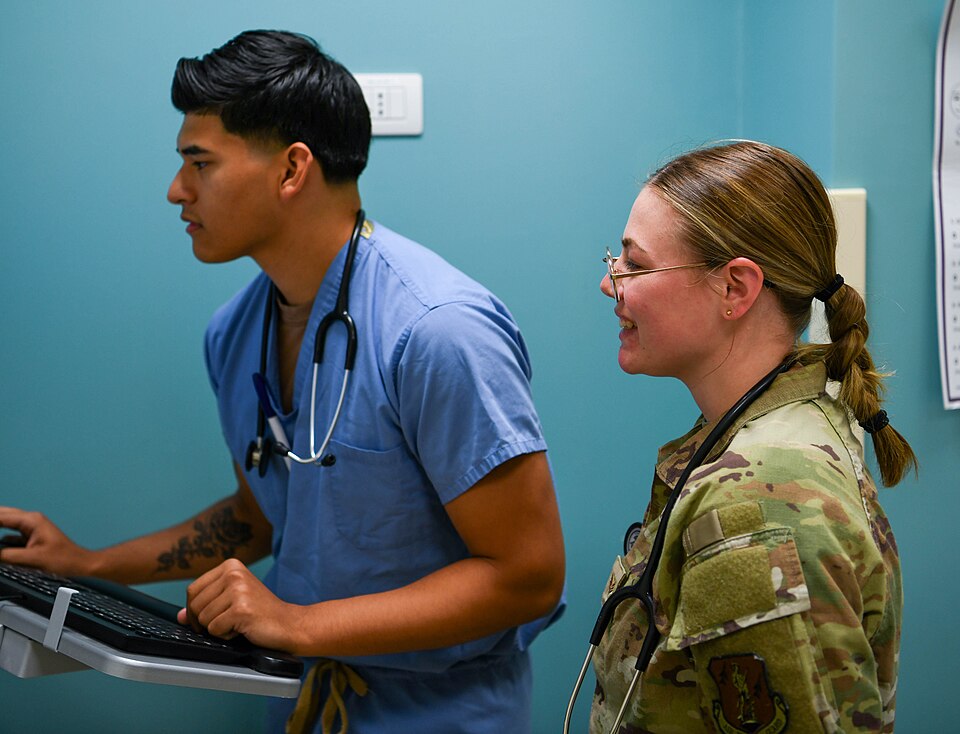 U.S. Air Force Senior Airman Taylor McGriff, right, works alongside a U.S. Navy Hospital Corpsman as part of the Medical Facility Annual Training at Naval Medical Readiness Training Command Sigonella, Italy, June 14, 2025. The MFAT program helps Air National Guard members maintain clinical readiness