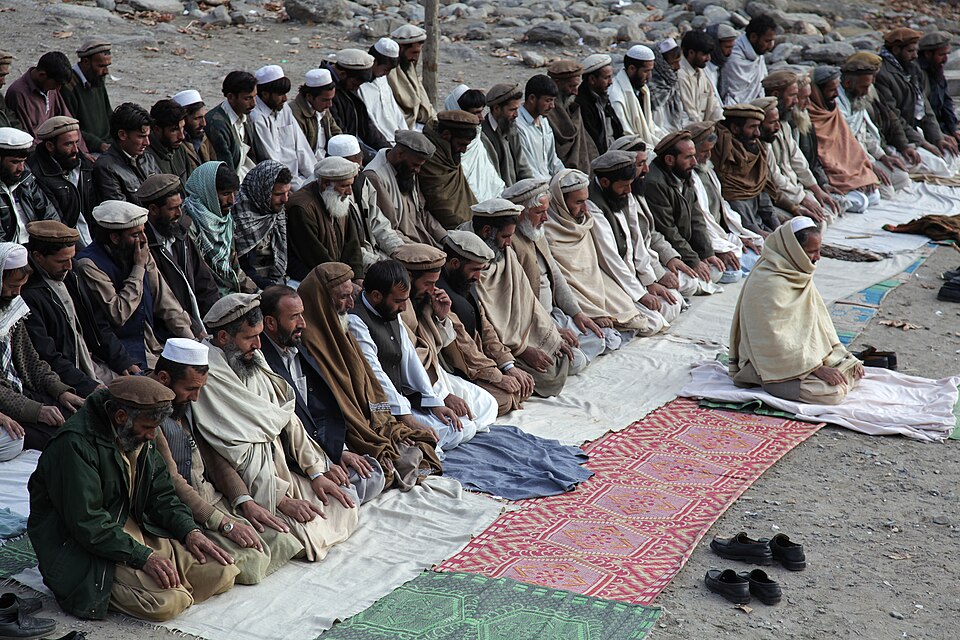 Afghan residents conduct an afternoon prayer after a key leader engagement with U.S. Soldiers assigned to Combat Company, 1st Battalion, 32nd Infantry Regiment, 3rd Brigade Combat Team, 10th Mountain Division in Lachey village, Shigal district, Kunar province, Afghanistan, Dec. 7, 2009.