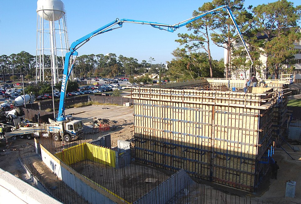 Construction workers pour concrete for the linear accelerator vault walls at Keesler Medical Center’s new diagnostic imaging center. A convoy of cement trucks made dozens of trips throughout the day to pour about 698 cubic yards of concrete using two large pumping booms.