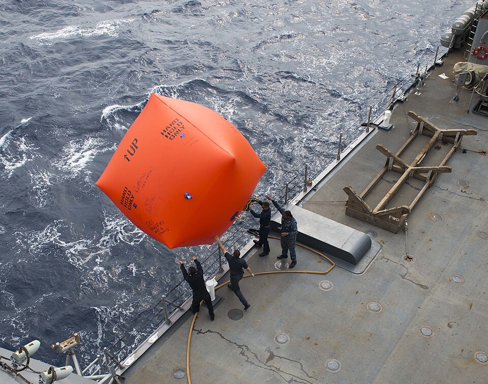 151102-N-SU278-202 WATERS OFF OKINAWA, Japan – Sailors assigned to the amphibious dock landing ship USS Germantown (LSD 42) throw a floating firearms target overboard during a gunnery demonstration. Germantown is hosting a “Tiger Cruise,” where family members and friends of the crew have a chance at
