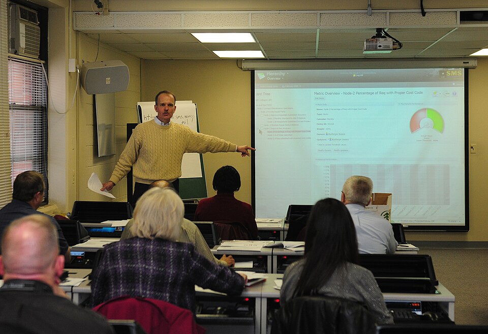Hank Sharpenberg, an instructor for the Strategic Management System, teaches logicians from Fort Carson and Fort Sill during a four-day class at the Fort Carson Training Support Center, Feb. 7, 2012. The students learned how to navigate the SMS, a computer program designed to help users create and g