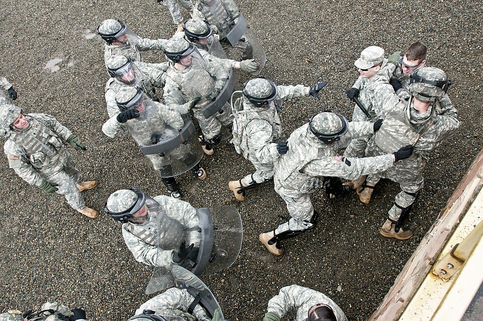 Soldiers with the 67th Military Police Company grab hold of a soldier playing the role of a restless prison inmate on Joint Base Lewis-McChord, Wash., Feb. 16 while practicing riot control drills during a culmination exercise that concluded a week of training for the soldiers. The company's leadersh