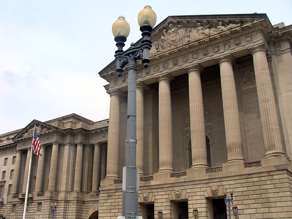 View of the entrance to the Andrew W. Mellon Auditorium. Constitution Avenuew, NW, Washington, DC. On the left is a portion of the former Department of Labor Building, now designated as part of the William Jefferson Clinton Federal Building, and which houses headquarters offices of the Environmental
