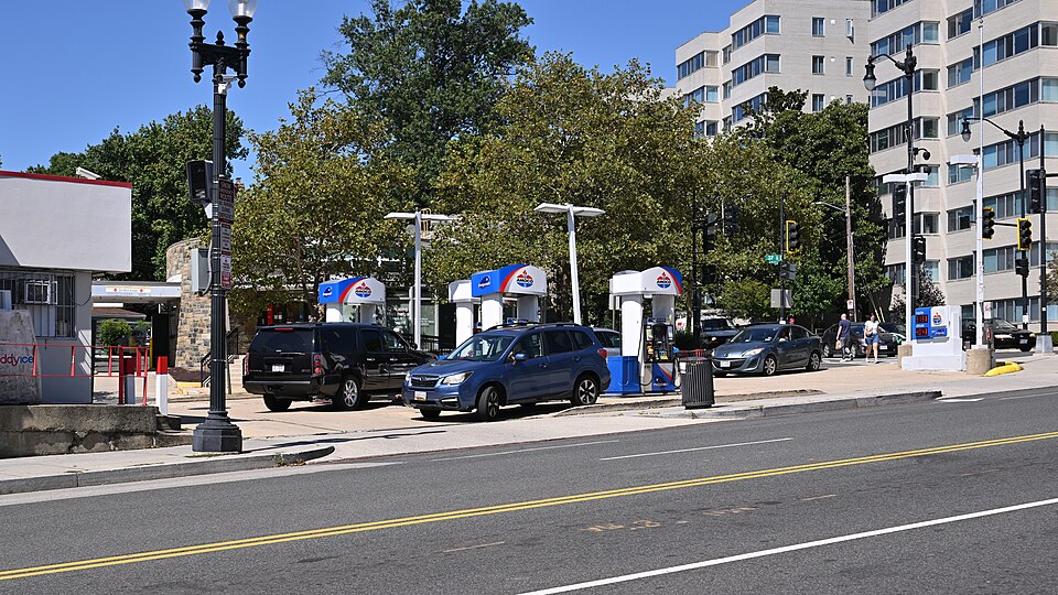 A busy Amoco gas station on a triangular parcel of land at the intersection of Wisconsin, 37th St and Calvert St. 2450 Wisconsin Avenue NW, Washington, DC 20007.