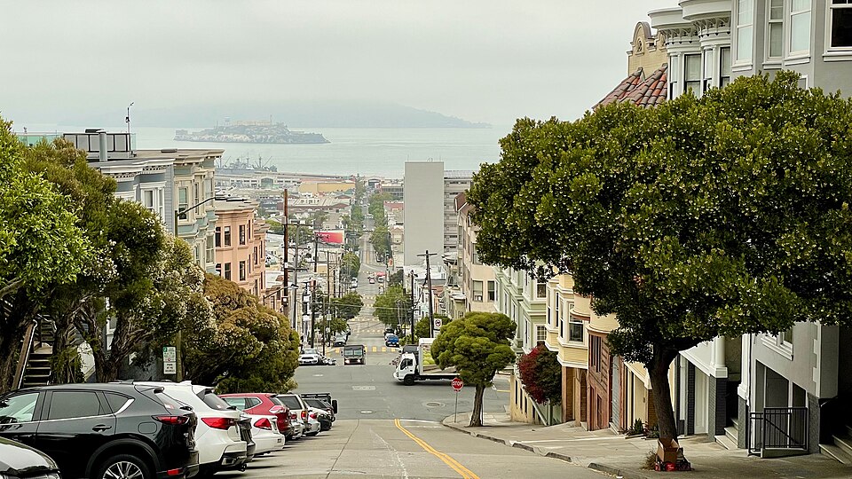 Photograph looking down Taylor Street in San Francisco, with a large portion of the city and the bay visible.