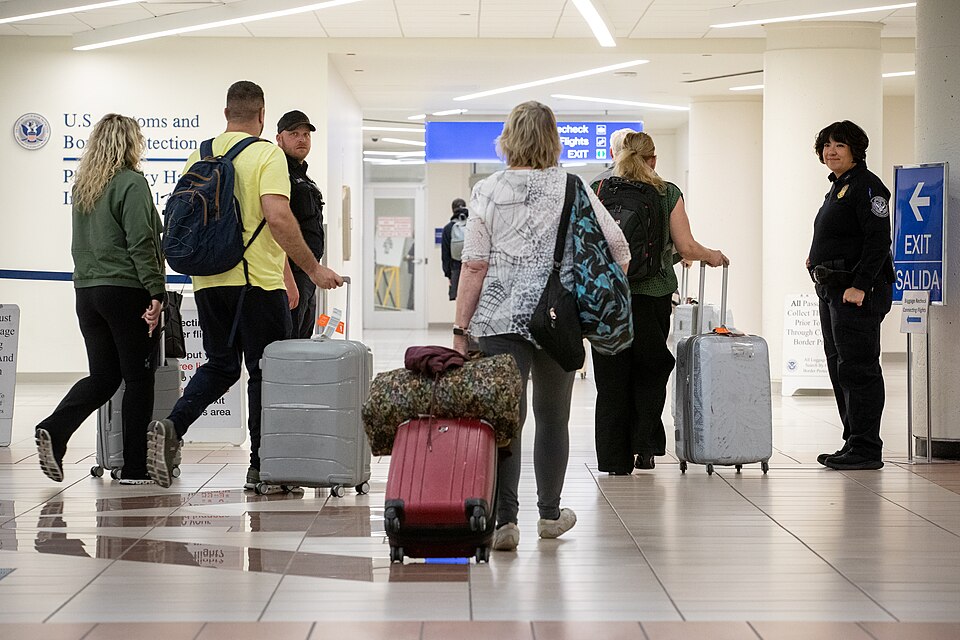 U.S. Customs and Border Protection officers direct arriving international passengers in the baggage claim area at Phoenix Sky Harbor International Airport in Phoenix, Ariz., December 11, 2024. CBP Photo by Jerry Glaser