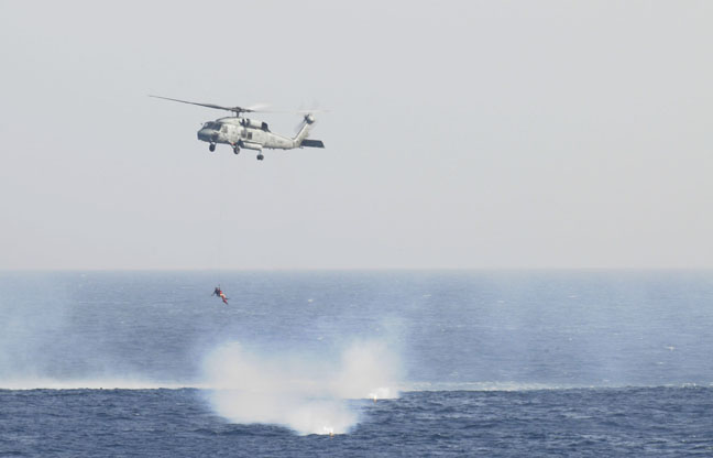 ARABIAN SEA (Feb. 4, 2011) Navy Aircrewman 3rd Class Toni Jester, assigned to Helicopter Anti-Submarine Squadron (HS) 15, is lowered from an HH-60H Sea Hawk helicopter to rescue a Sailor who went overboard from the aircraft carrier USS Carl Vinson (CVN 70). Carl Vinson is in the U.S. 5th Fleet area 