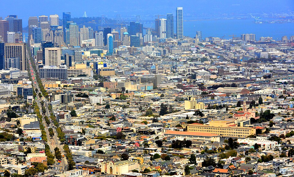The area in the centre of the picture was at one time simply known as "South of Market (Street)" and over time the name has been shortened.  Once an industrial area with many warehouses it's now a large area of smart nightspots, hotels, art spaces, loft apartments, and, yes, still some warehouses.
M