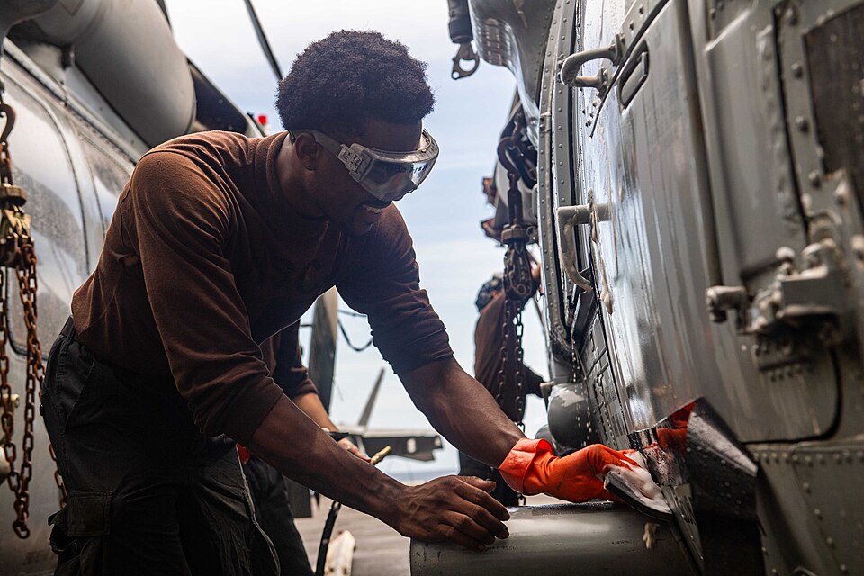 INDIAN OCEAN (Sept. 13, 2024) A U.S. Navy Aviation Structural Mechanic 3rd Class Jaedan George, from New York City, cleans an MH-60S Sea Hawk, assigned to the “Eightballers” of Helicopter Sea Combat Squadron (HSC) 8, aboard the Nimitz-class aircraft carrier USS Theodore Roosevelt (CVN 71), Sept. 13,