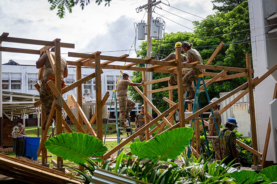 U.S. Army Soldiers with 871st Engineer Company, 411th Engineer Battalion, 303rd Maneuver Enhancement Brigade, 9th Mission Support Command, construct an exterior corridor during a renovation project with U.S. Marines with Task Force Koa Moana 23 at Chuuk High School on Weno, Chuuk, Federated States o