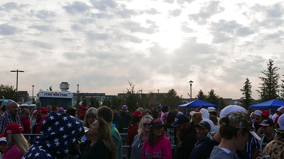 The sun pokes through the clouds at a political rally.