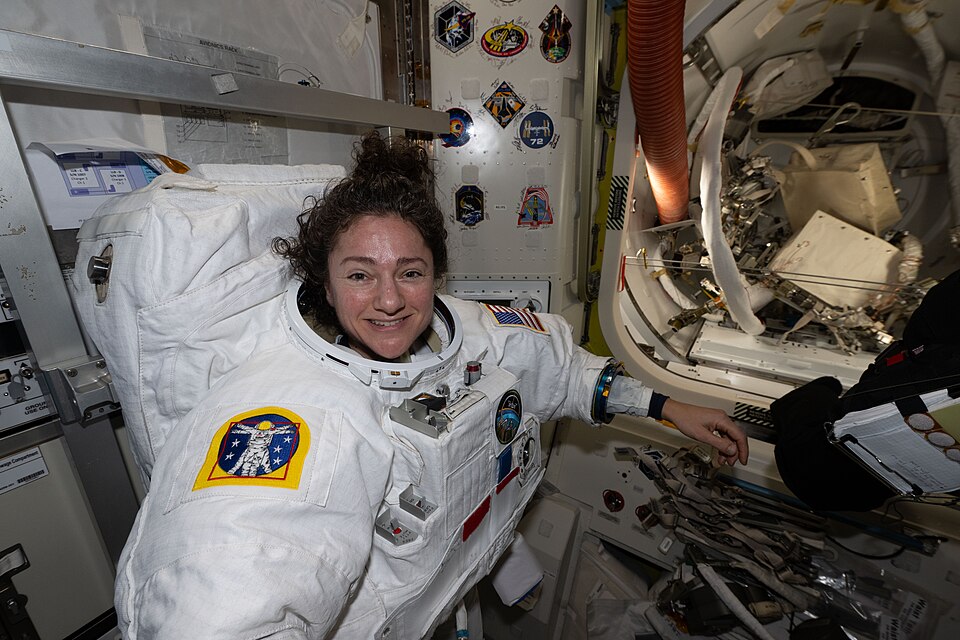 iss074e0760518 (June 23, 2026) --- NASA astronaut and Expedition 74 flight engineer Jessica Meir tries on her spacesuit, testing its comfort and mobility as well as its communications and life support systems inside the International Space Station’s Quest airlock. Meir was preparing for a spacewalk 