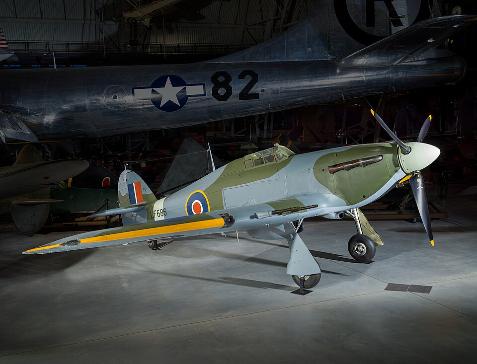 Hawker Hurricane Mk. IIC single seat, low wing monoplane ground attack fighter; enclosed cockpit; steel tube fuselage with aircraft spruce forms and fabric, aluminum cowling, stressed skin aluminum wings and horizontal stablizer, fabric covered aluminum rudder and control surfaces; grey green camouf