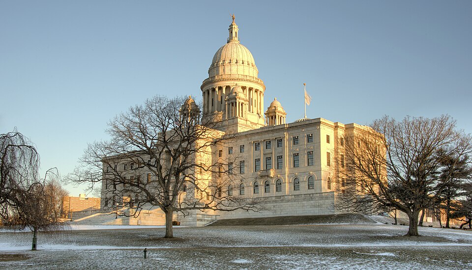 The Rhode Island State House is the capitol of the U.S. state of Rhode Island. It is located on the border of the Downtown and Smith Hill sections of the state capital city of Providence. The State House is a neoclassical building that houses the Rhode Island General Assembly and the offices of the 