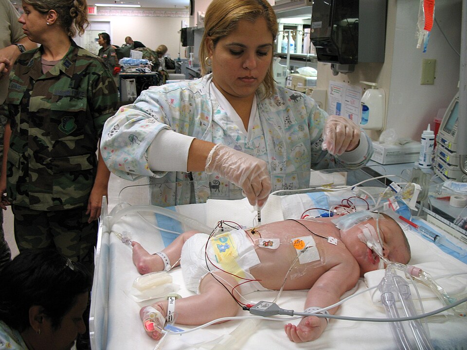 Respiratory therapist Michelle Sirra takes a blood sample from a 3-day-old patient in preparation for transfer to an Extracorporeal Membrane Oxygenation unit on Friday, July 21, in San Juan, Puerto Rico. An ECMO team comprised Air Force and Army medical specialists from the Wilford Hall Medical Cent