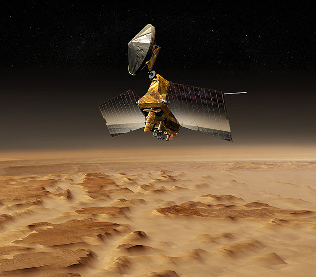 Mars Reconnaissance Orbiter over Nilosyrtis Mensae - In this image, a graphic representation of the Mars Reconnaissance Orbiter flies over a bumpy martian landscape.  The spacecraft's solar panels are spread open and look like two large billboards.  In between the solar panels is the main, boxy bus 