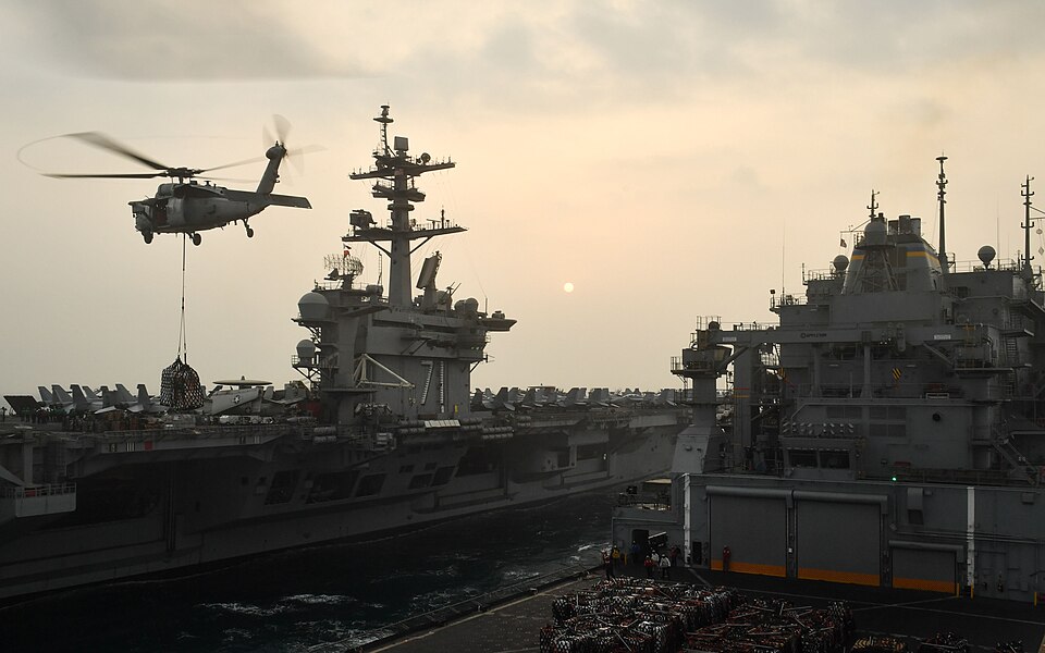 ARABIAN GULF (Feb. 15, 2018) An MH-60S Sea Hawk helicopter assigned to the Indians of Helicopter Sea Combat Squadron (HSC) 6 transports cargo from the dry cargo and ammunition ship USNS Alan Shepard (T-AKE 3) to the aircraft carrier USS Theodore Roosevelt (CVN 71) during a replenishment-at-sea. Theo