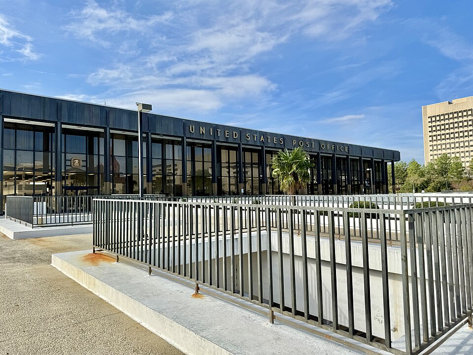 Built in 1966, this Modern International-style building was designed by Lyles, Bissett, Carlisle and Wolff to serve as the main Post Office for the city of Columbia, with the building’s design taking advantage of the site’s topography.  The site includes a smaller one-story red brick structure and a