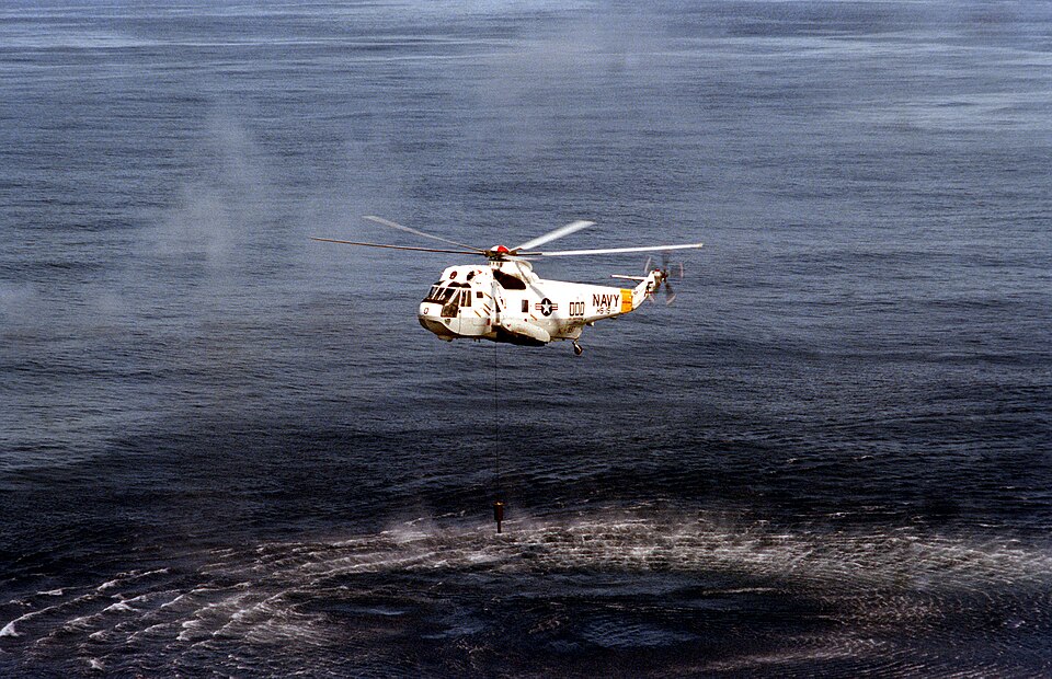 A U.S. Navy Sikorsky SH-3H Sea King helicopter from Helicopter Antisubmarine Squadron 15 (HS-15) Red Lions lowers its AN/AQS-13 sonar during anti-submarine operations off the Virginia Cape. HS-15 was assigned to Carrier Air Wing 6 (CVW-6) aboard the aircraft carrier USS Independence (CV-62) for a de