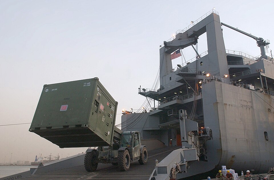 Port Shueiba, Kuwait (July 9, 2003) -- A U.S Marine tractor lifts a shipping container into the cargo bay of the Military Sealift Command ship USNS Charlton (T-AKR 314).  The equipment is part of the 1st Marine Expeditionary Force (1st MEF), which is returning to the U.S. after participating in Oper