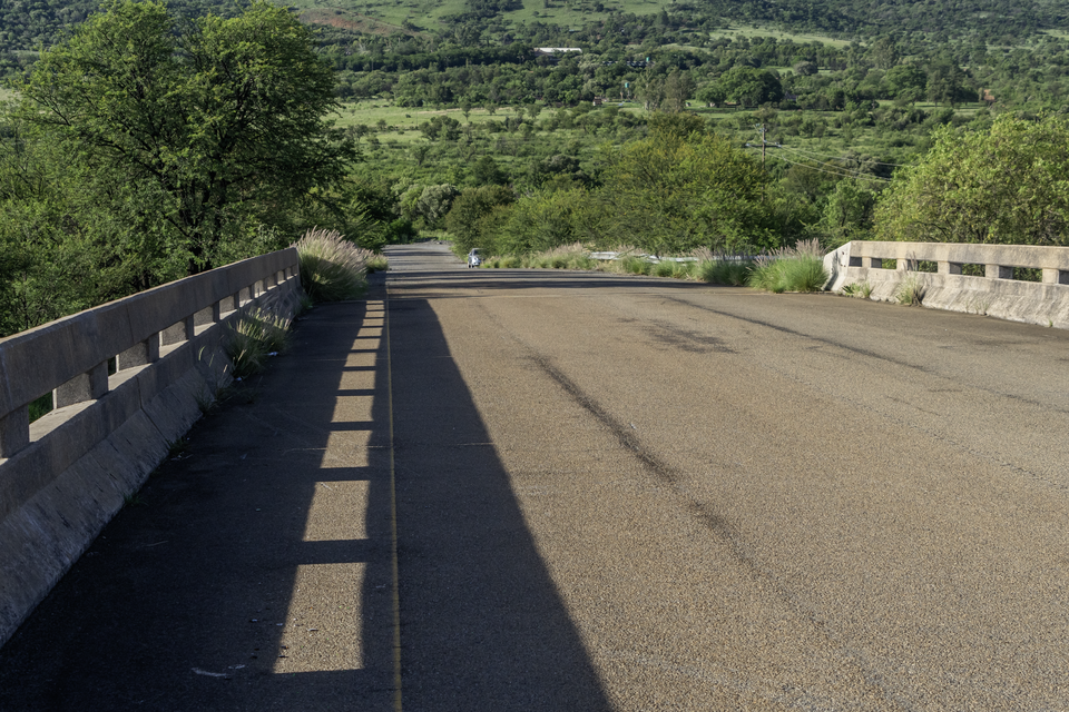 Run-down overpass with a view of a run-down road. EVs: 21, WB: 5400K.
