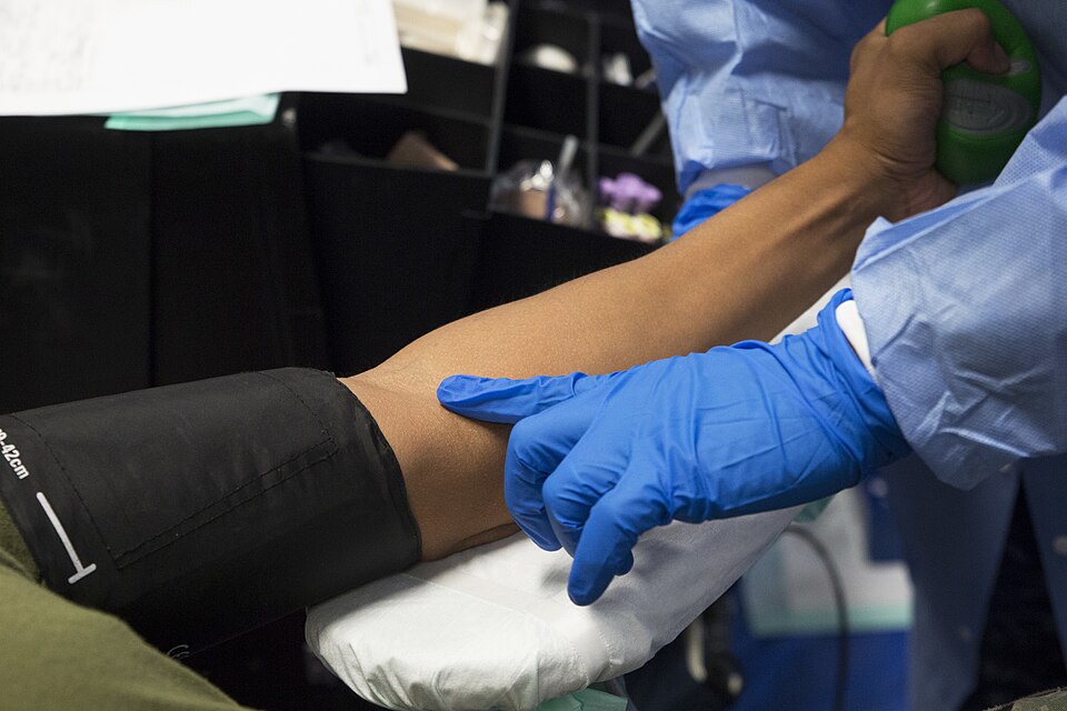 A hospital corpsman probes for a vein while preparing to collect a donor’s blood during a U.S. Pacific Command Armed Services Blood Bank Center blood drive Nov. 3, 2016 aboard Camp Foster, Okinawa, Japan. The library blood drive is a periodic event hosted by the ASBBC to maintain the blood supply fo