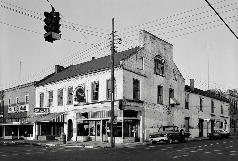 Pope Building, 625-627 Market Street, Port Gibson, Mississippi, photographed April 1972. 

General View from Southwest. Building front shows "Auto Lec" shop at ground floor left, "Rexall Drugs" shop at ground floor right, and at center archway with stairs to upper story. Signage on next building to 