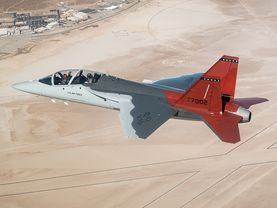 The first T-7A Red Hawk, piloted by USAF test pilot Maj. Jonathan“Gremlin” Aronoff and Boeing test pilot Steve “Bull” Schmidt, soars over Edwards Air Force Base, California, Nov. 8, prior to arrival. The T-7A will replace the 1960s-era T-38 aircraft by providing advanced pilot training capabilities 