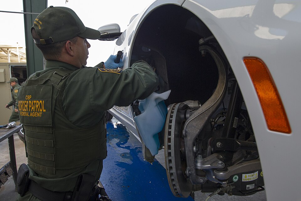 South Texas Customs and Border Protection Check Point Inspection Station on September 25, 2013.  Border Patrol agent checks vehicle for hidden drugs.

Photographer: Donna Burton