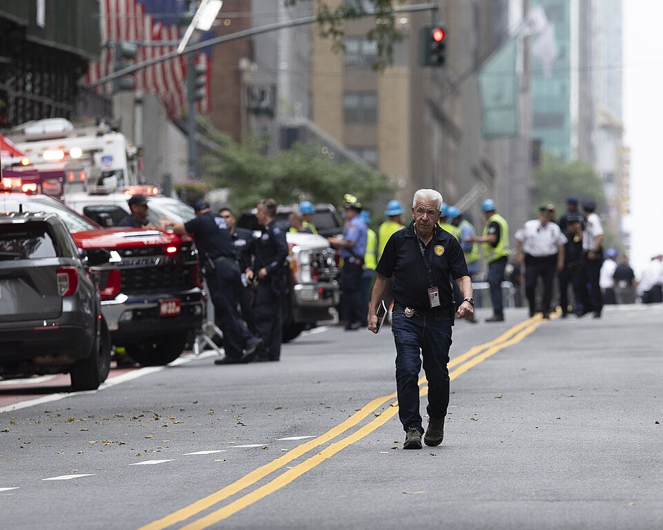 Emergency vehicles, responders, and construction workers near the former Pfizer Building at 235 East 42nd Street in Midtown Manhattan on Tuesday, July 7, 2026.