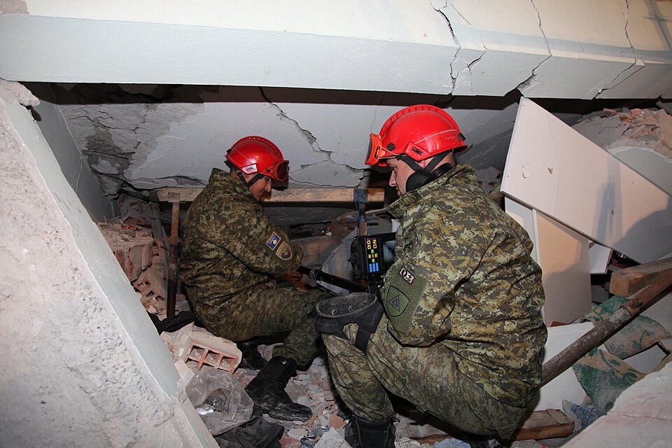 Kosovo Security Force rescuers searching for survivors in the rubble of a collapsed building after the 2019 Albania earthquake.