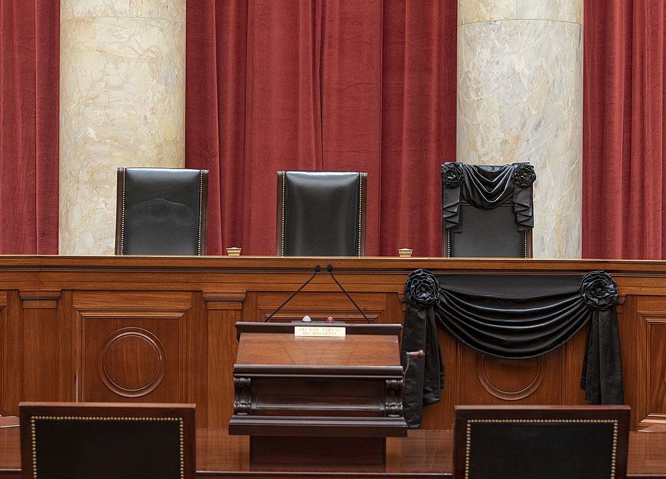 The Courtroom of the Supreme Court showing Associate Justice Ruth Bader Ginsburg’s Bench Chair and the Bench in front of her seat draped in black following her death on September 18, 2020.