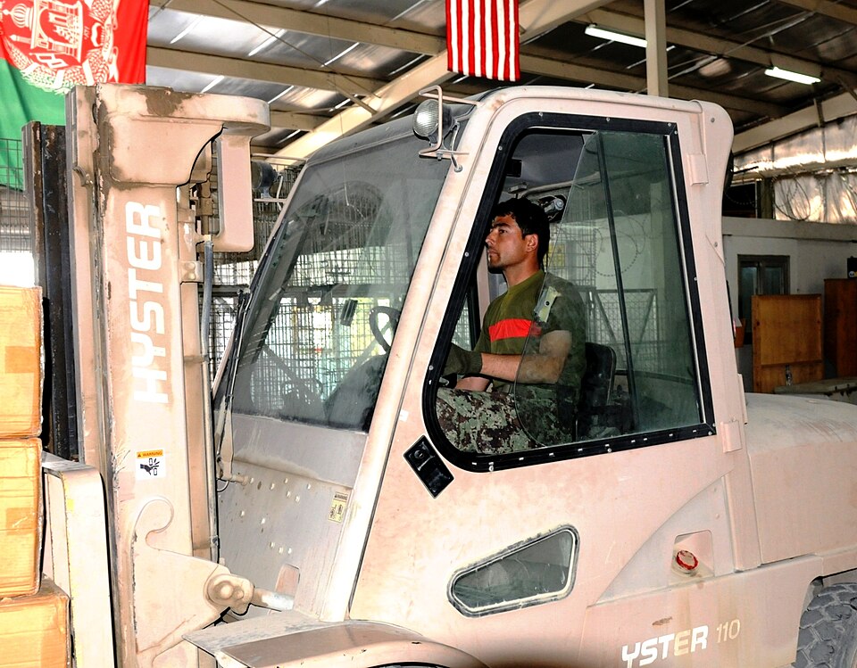 An Afghan National Army soldier uses a forklift to move a pallet of boxes containing cold-weather gear at the Camp Hero Forward Supply Depot Oct. 30, at Kandahar, Afghanistan.  ANA soldiers spent four days unloading 19 trucks filled with cold-weather gear, which will be distributed to units within t