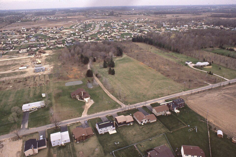 An aerial view looking south of the Olde Sawmill neighborhood including portions of what would become the Summit View Forest subdivision. Summit View Road runs, left to right, east to west across the bottom half of the photograph. Featured properties include 2399 Summit View Road, at the middle righ