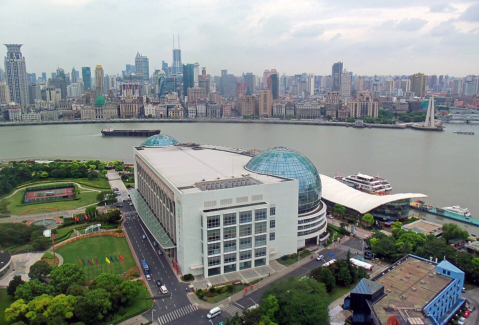 View west from the 90 m observation platform at the Oriental Pearl Tower of the Shanghai International Conference Center, Huangpu River, the Bund, and the cityscape beyond