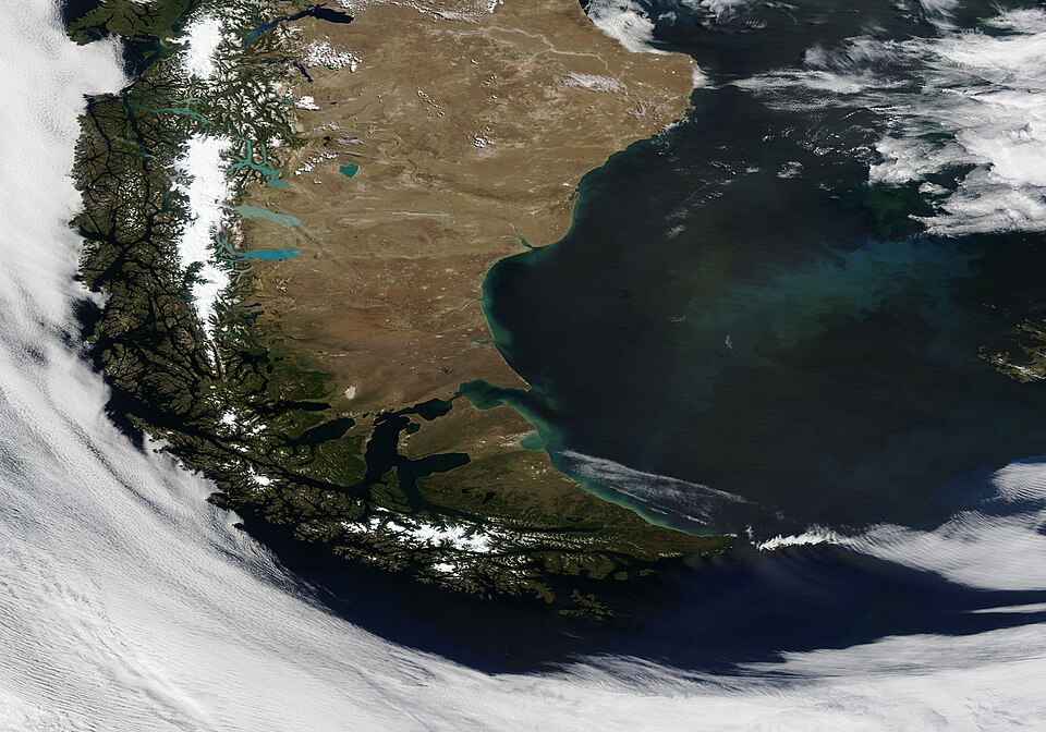 On January 20, 2022, the Moderate Resolution Imaging Spectroradiometer (MODIS) on board NASA’s Terra satellite acquired a dramatic true-color image of Patagonia surrounded by a swirl of cloud. On this clear summer day, almost all of Patagonia can be seen, from Chile’s verdant Pacific coast, to the s