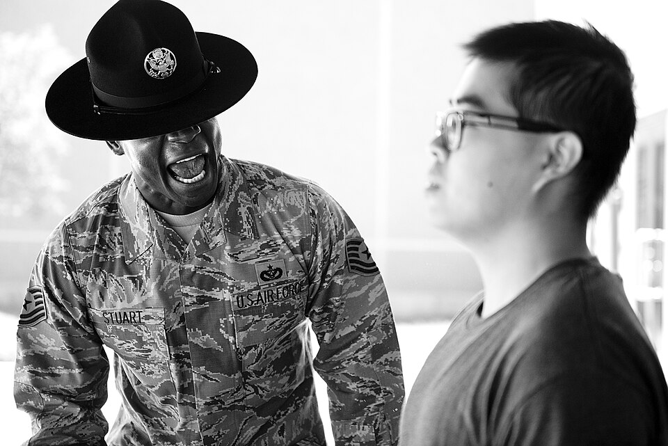 Tech. Sgt. Chananyah Stuart reminds a trainee of the procedures for entering the dining facility Sept. 26, 2014, at Joint Base San Antonio-Lackland, Texas. Stuart is extra demanding on his trainees from the very beginning because he believes it sets them up for success. Stuart is a 323rd training Sq