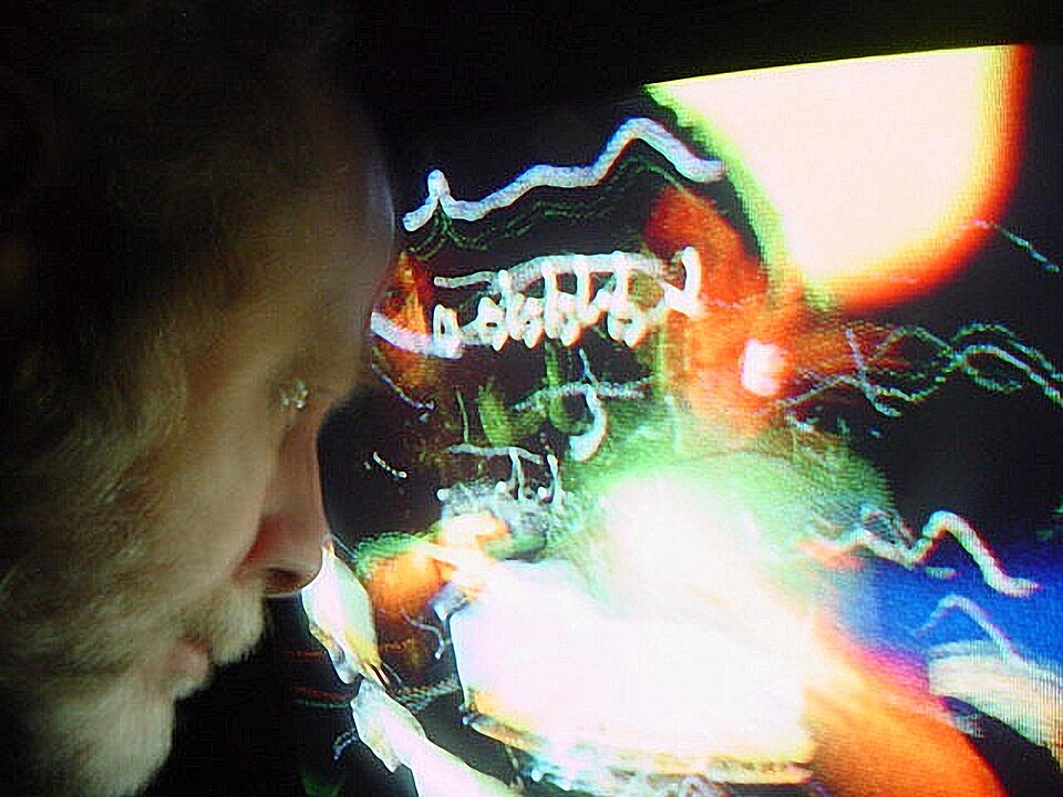 Early digital photography self-portrait with a Sony FD Mavica. Candid handheld photograph at a very slow shutter speed  shot under available light. Effects were created with photography and not created with computer graphics. Experimental digital photography by Rick Doble.