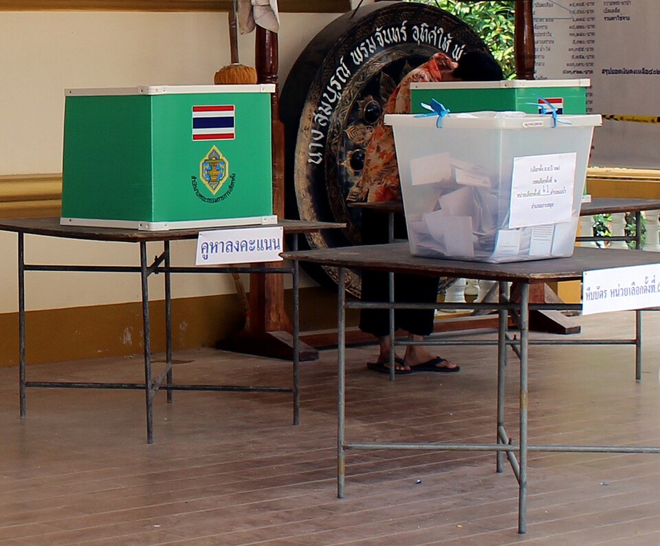 A voter casts ballot in a voting booth at the 2019 Thai general election.