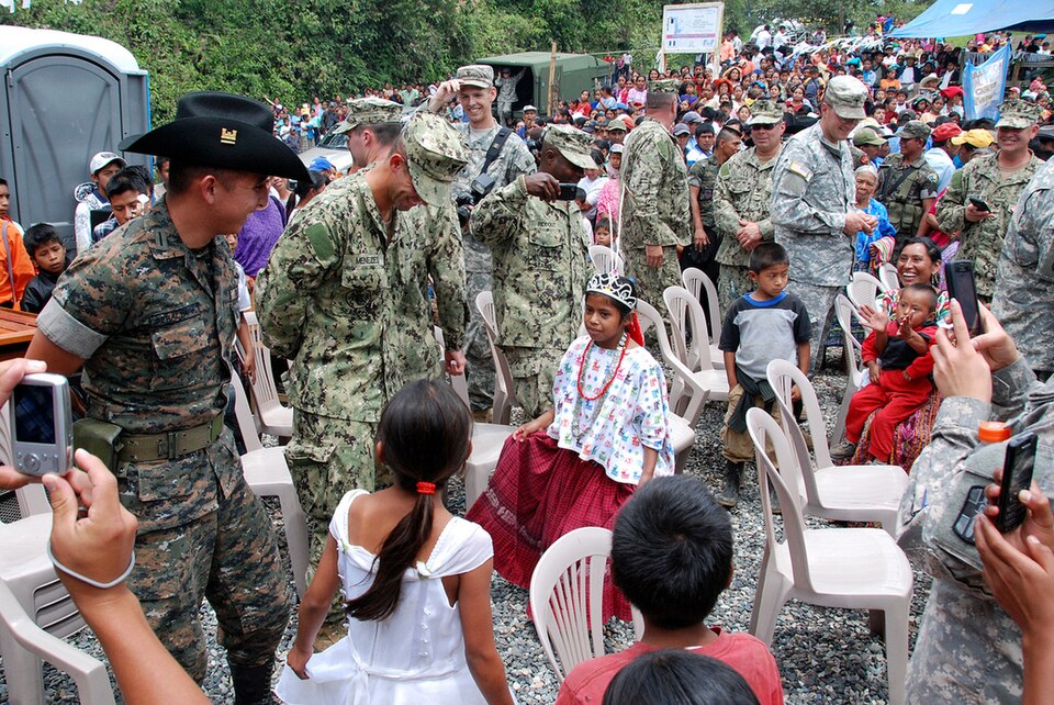 U.S. Army and Navy engineers dance along with Guatemalan army engineers and local children during a ribbon-cutting ceremony at the El Rancho medical clinic near Coban, Guatemala. Construction of the clinic was part of Beyond the Horizon 2012 Guatemala, a U.S. Army South exercise deploying military e