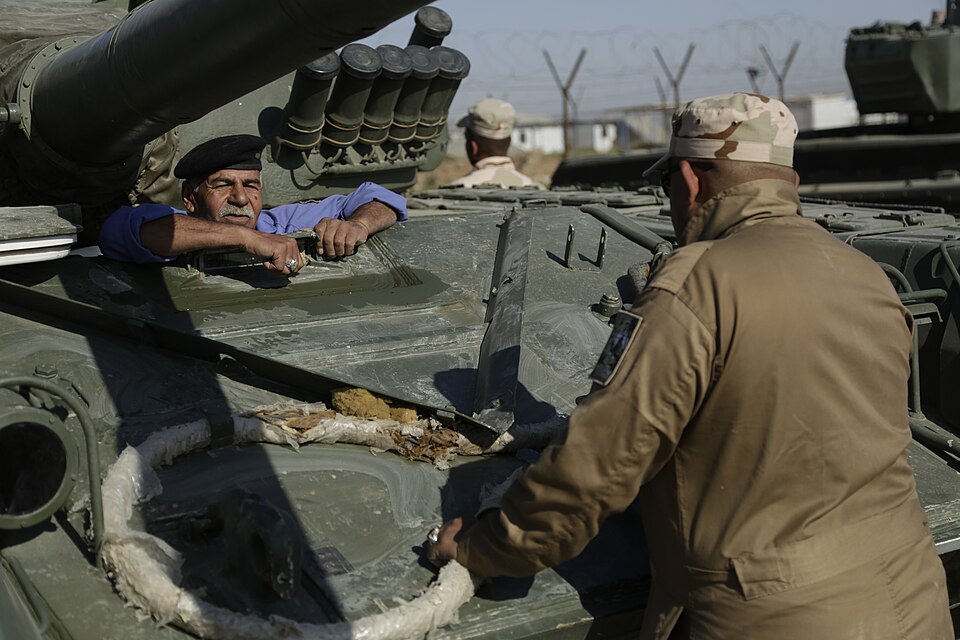 An Iraqi soldier with 2nd Battalion, 35th Iraqi Army Brigade, listens to T-72 tank driver’s compartm