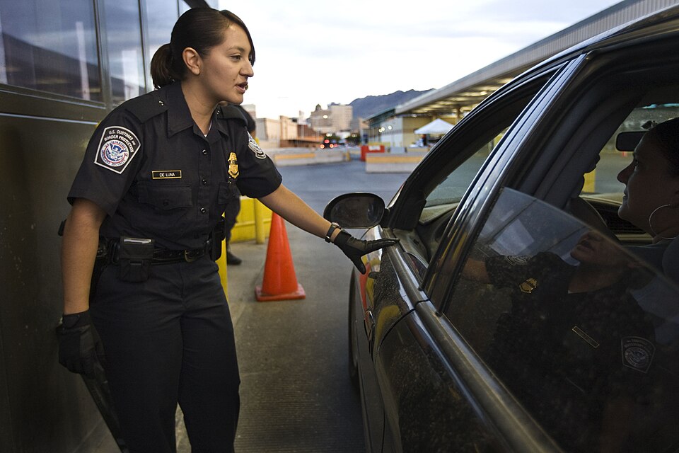 CBP Officer checks vehicles entering the United States at a border crossing point of entry.