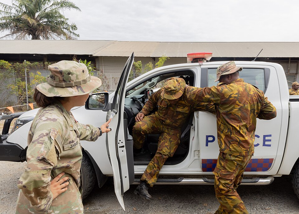 U.S. Army Pvt. Crystal Jaimes, a military police officer assigned to the 8th Military Police Brigade, 8th Theater Sustainment Command, watches as Papua New Guinea Defence Force Pvt. Sepi Walbo, a military police officer, pulls PNGDF Pvt. Jesse Malon, a clerk, both assigned to Command Headquarters, o
