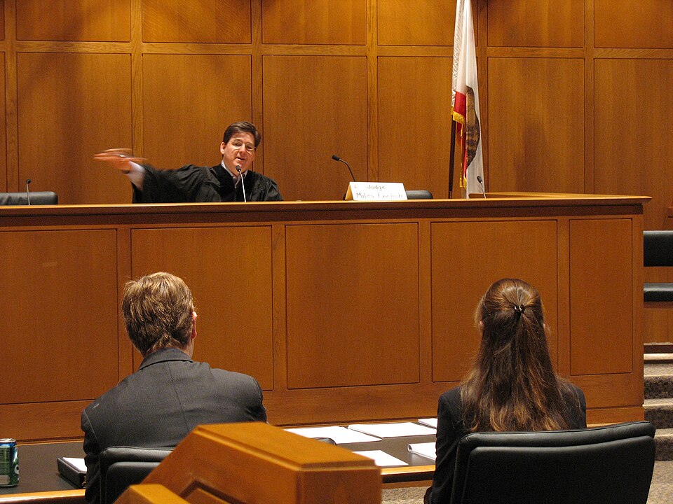 American judge Miles Ehrlich talking to a lawyer.