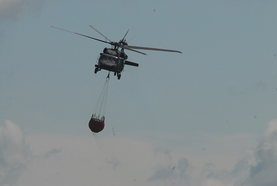 A New York Army National Guard UH-60 Black Hawk based in Latham, N.Y., heads out to conduct swift load and drop water bucket training at the Round Lake municipal airport, June 4. The New York Army National Guard and New York State Police trained their helicopter crews to prepare to fight wildfires a
