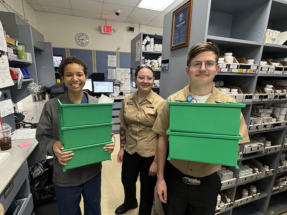 Hospital Corpsman Amanda Rodriguez, Hospital Corpsman 3rd Class Winter McKinnon and Hospital Corpsman 3rd Class Ryan Holton, pharmacy technicians at Naval Hospital Guantanamo Bay, prepare to take boxes of medications to load automated dispensing machines (ADM), Jan. 12, 2024. The ADMs are used to se