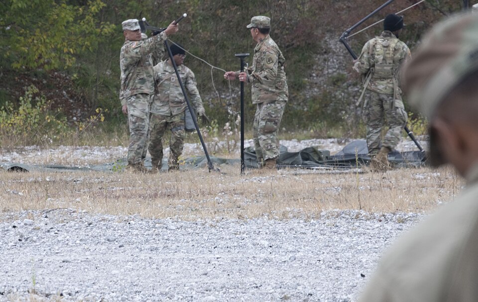 Soldiers of the 509th Signal Battalion set up a tent for shelter during a Field Training Exercise (FTX)on October 20 at Aviano airfield. The FTX was designed to refresh basic soldiering skills.